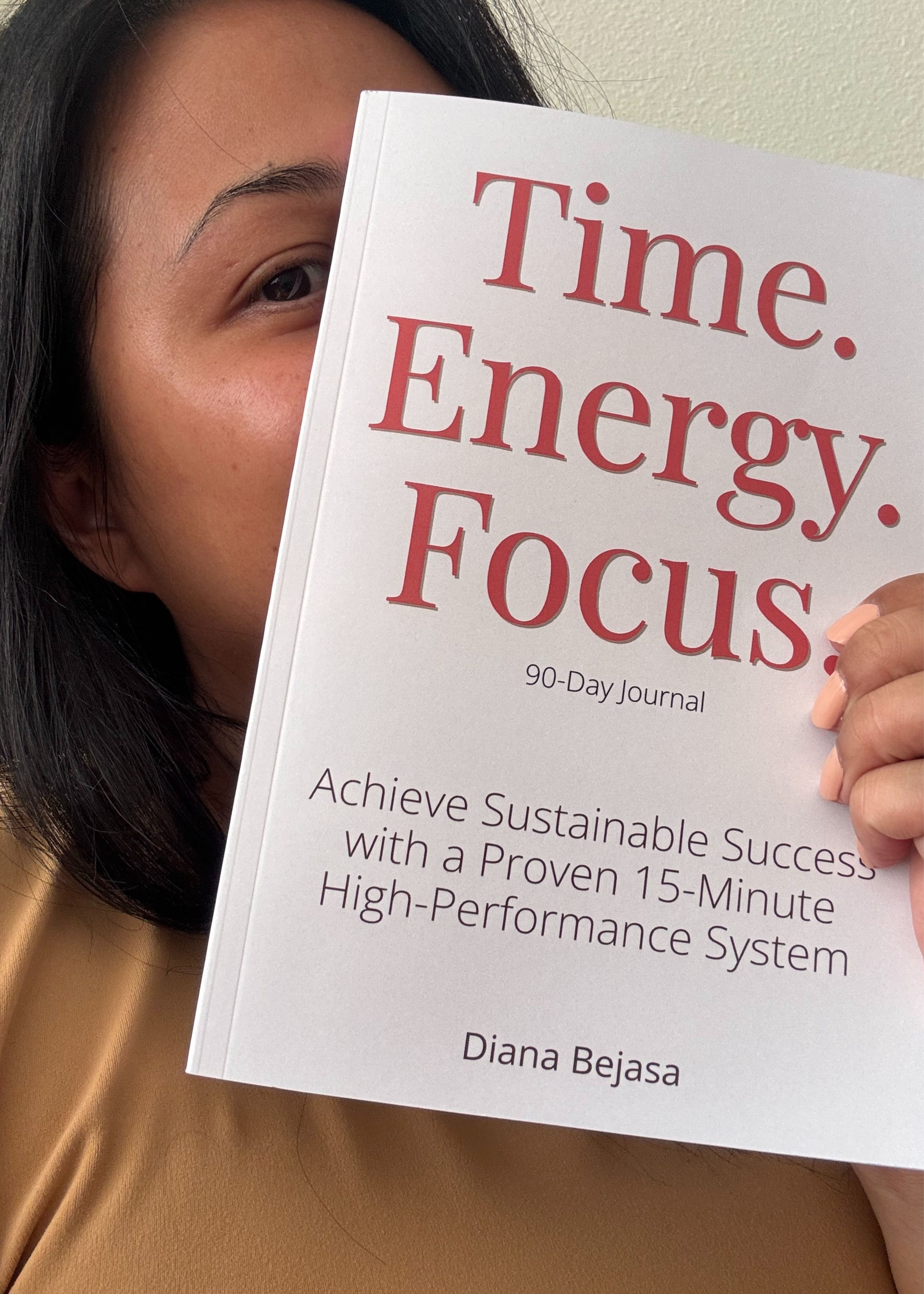 Diana Bejasa, author of the Time Energy Focus journal, holding a copy of her book.