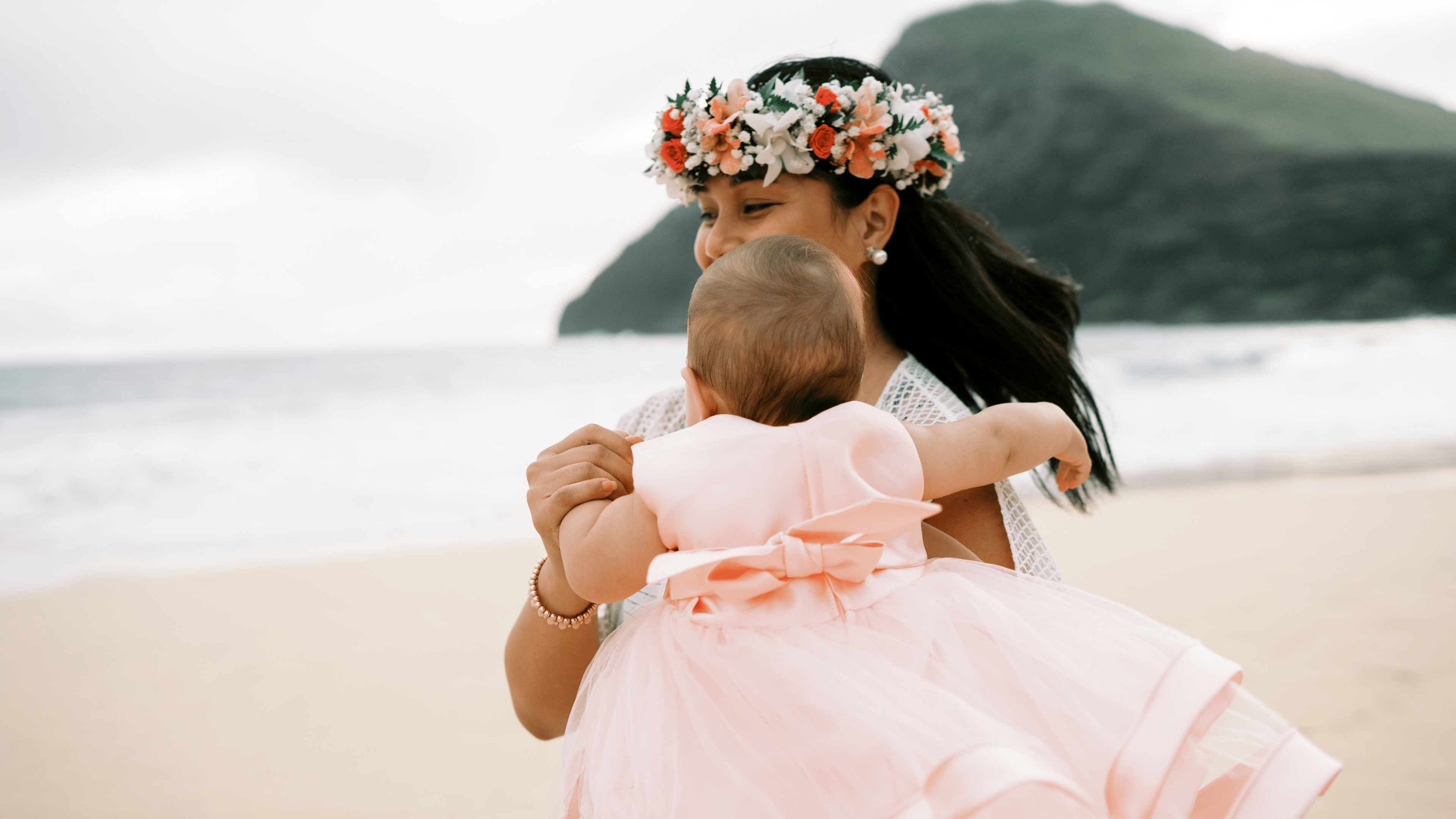 Diana Bejasa dancing with her daughter on a beach in Honolulu, representing balance, love, and purpose.