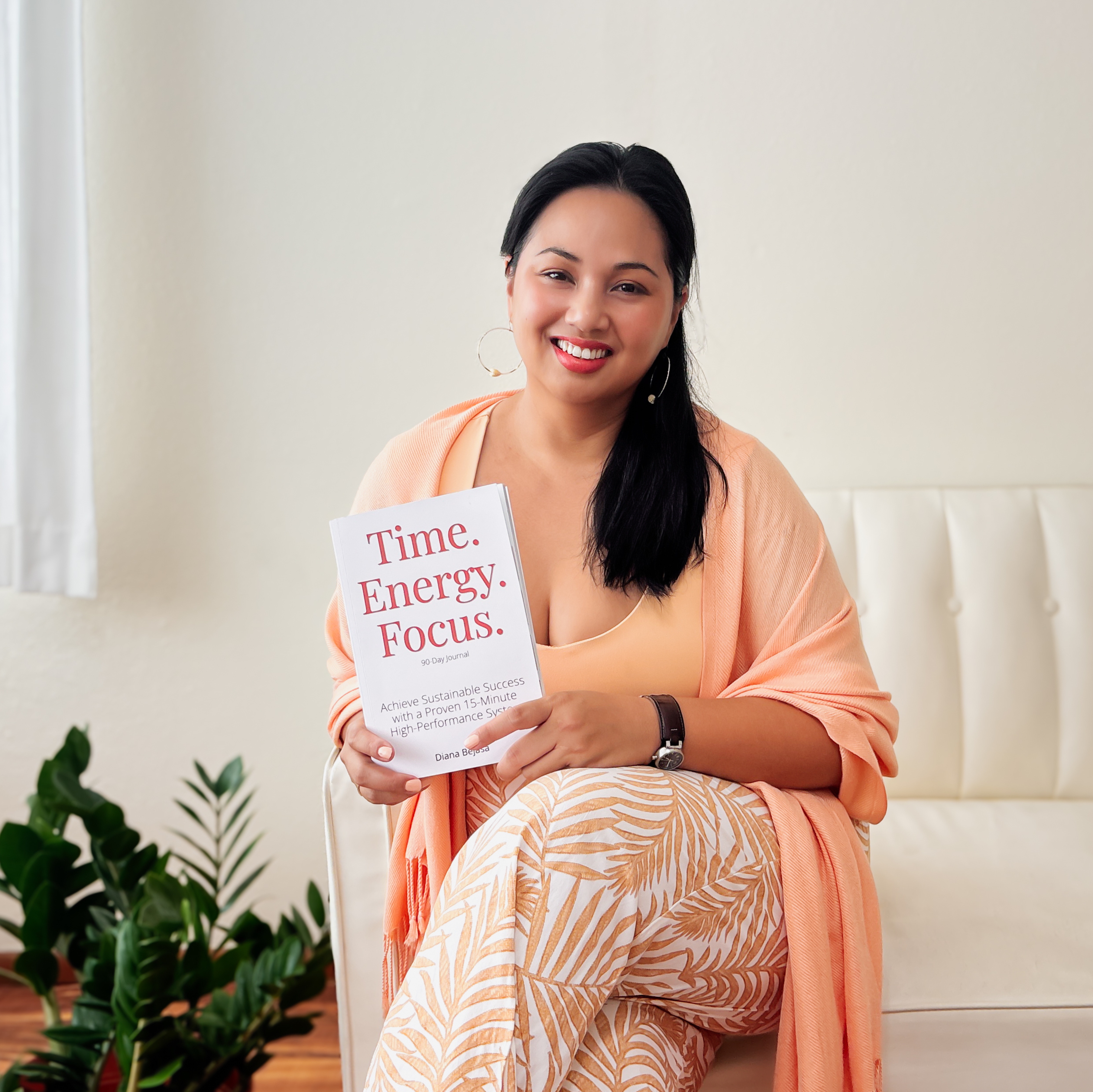 Diana Bejasa, author of the Time Energy Focus journal, holding a copy of her book.
