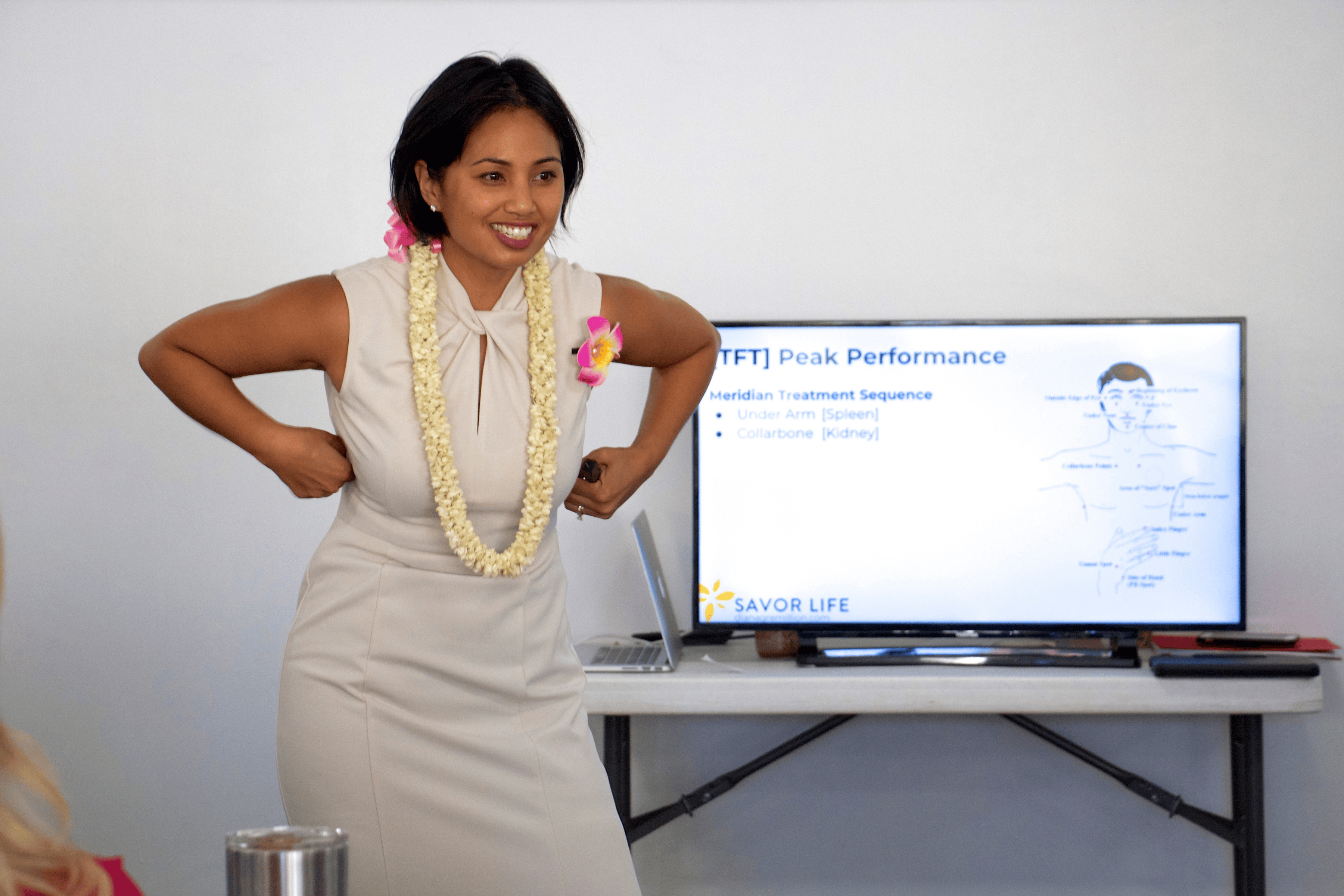 Diana Bejasa demonstrating a TFT meridian tapping sequence for peak performance during a live training.