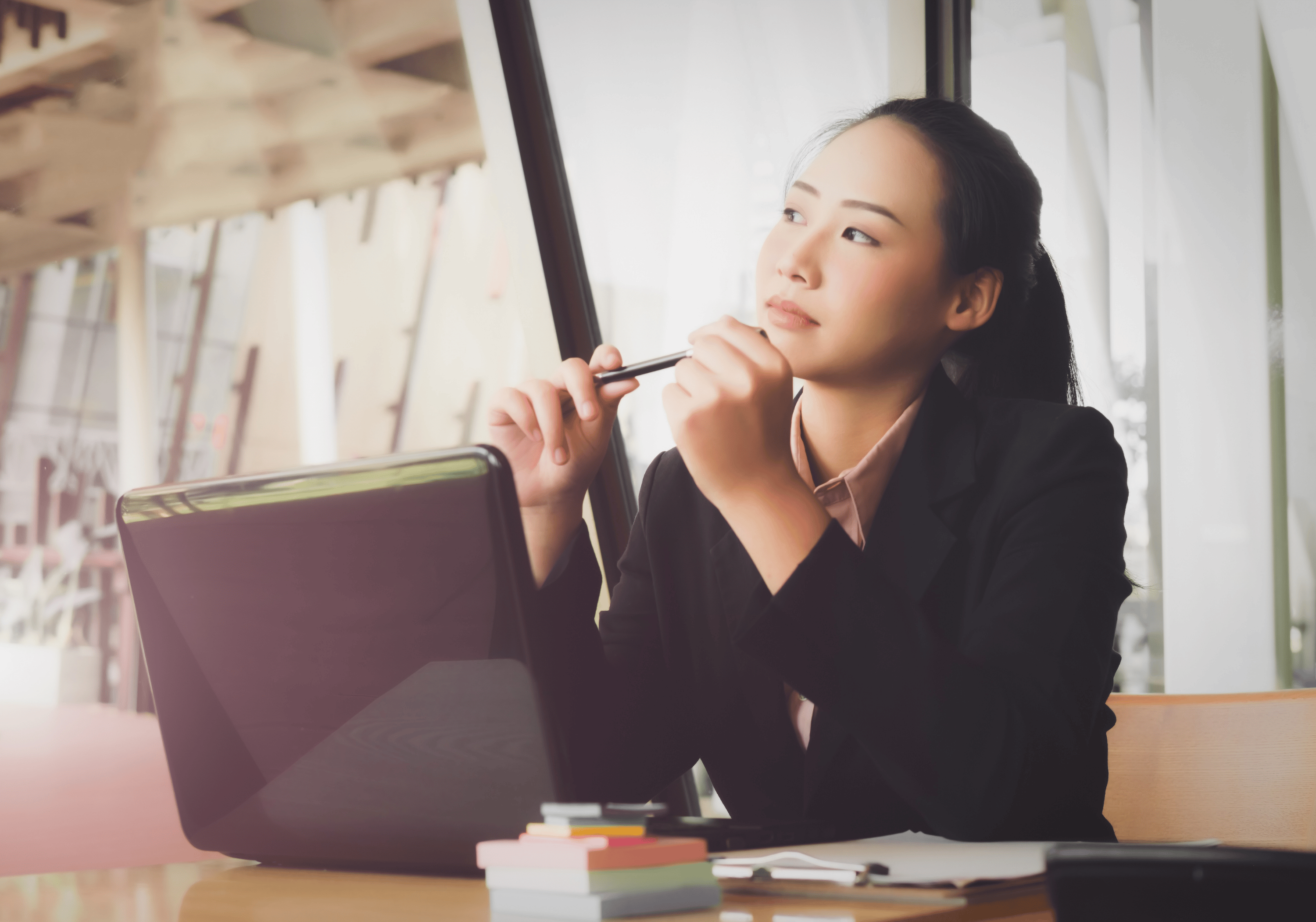 A professional woman in a moment of reflection, symbolizing the shift from burnout to clarity and renewed focus.