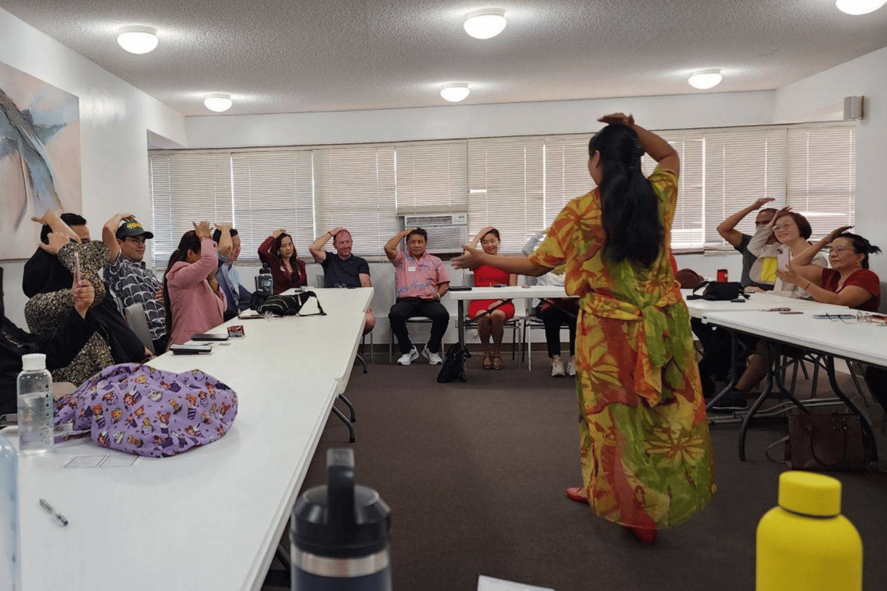 Diana Bejasa leading a group of international business leaders through a Thought Field Therapy tapping sequence during a live presentation in Hawai‘i.