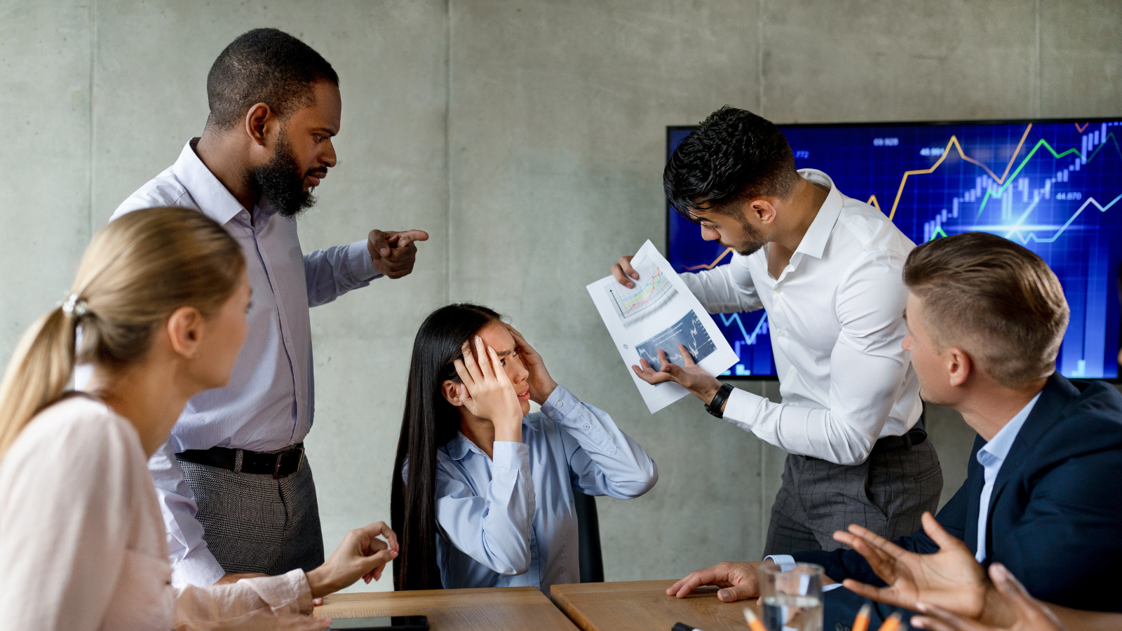 Workplace conflict and stress symbolizing the high cost of toxic hustle culture and burnout in leadership teams.