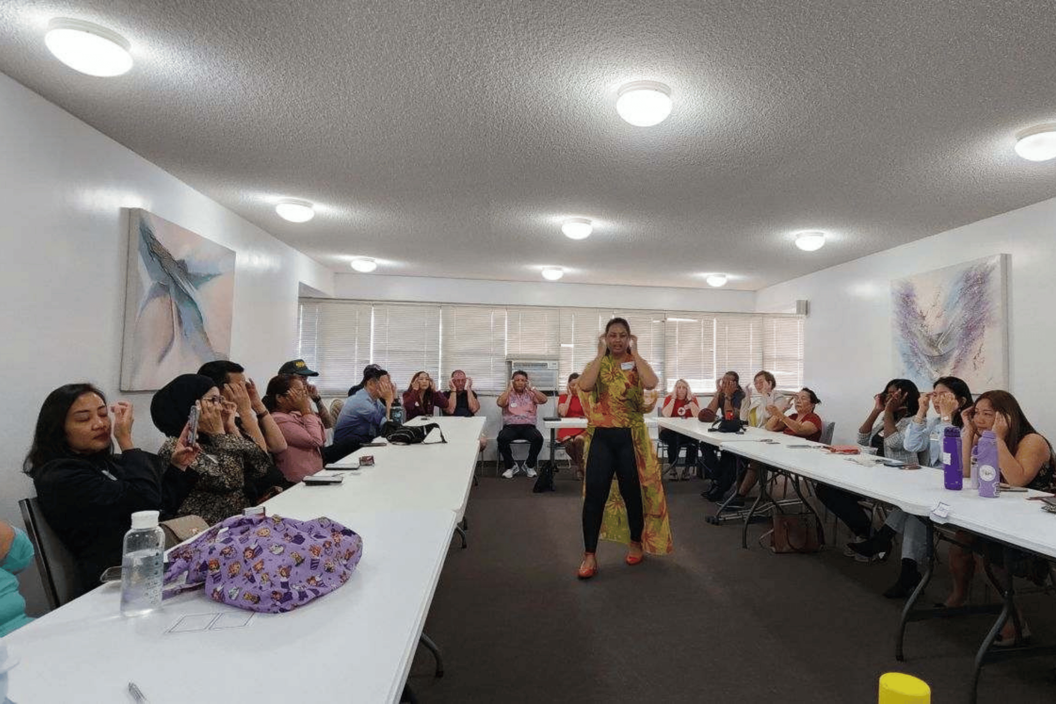 Diana Bejasa leading a group through a Thought Field Therapy tapping sequence during a stress relief workshop in Hawai‘i.